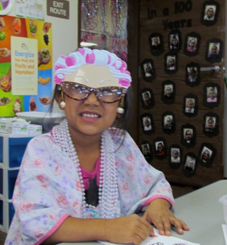 Analicia Placencia shows off her "100-year-old woman" mask while she colors on the Soboba kindergarten class' 100th day of instruction Analicia Placencia shows off her "100-year-old woman" mask while she colors on the Soboba kindergarten class' 100th day of instruction