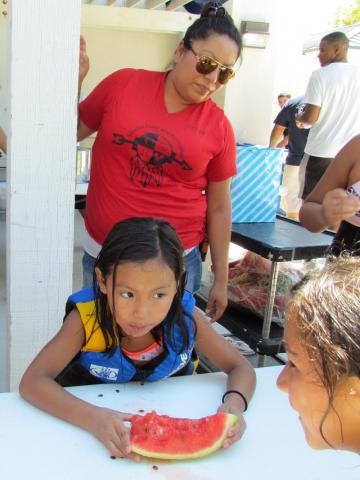 Jennifer DeVore-Garcia watches as Candice DeVore, 5, closes in on the win for her age group in the watermelon-eating contest during the End of Summer Bash Jennifer DeVore-Garcia watches as Candice DeVore, 5, closes in on the win for her age group in the watermelon-eating contest during the End of Summer Bash