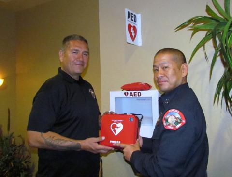 Soboba Tribal Administrator Michael Castello, left, accepts the first AED from Fire Capt. Roger Salmo at the administration building on March 29 Soboba Tribal Administrator Michael Castello, left, accepts the first AED from Fire Capt. Roger Salmo at the administration building on March 29