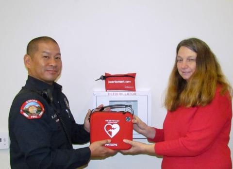 Soboba Tribal Preschool Kindergarten teacher Cindy Lee helps Fire Capt. Roger Salmo place an AED unit at the multipurpose room on March 29 Soboba Tribal Preschool Kindergarten teacher Cindy Lee helps Fire Capt. Roger Salmo place an AED unit at the multipurpose room on March 29