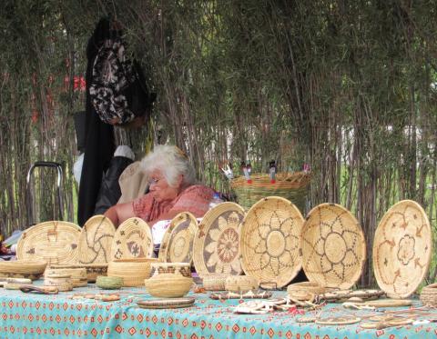 Mary Margaret Masiel is seated behind a display of many of the Kumeyaay baskets made by renowned basketweaver Eva Salazar from San Jose De La Zorra, Baja California Mary Margaret Masiel is seated behind a display of many of the Kumeyaay baskets made by renowned basketweaver Eva Salazar from San Jose De La Zorra, Baja California