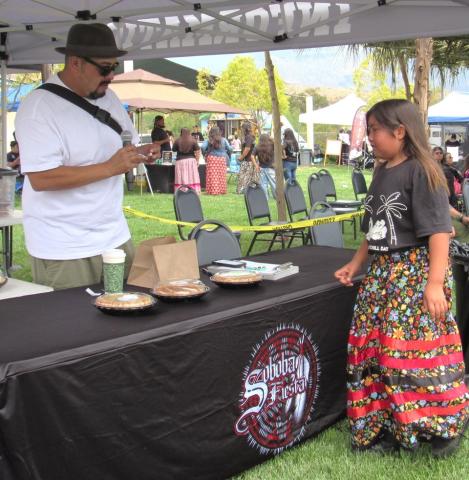 Tribal Historic Preservation Officer Joseph Ontiveros, who also served as emcee at the Soboba Fiesta, helps a cakewalk winner choose her prize Tribal Historic Preservation Officer Joseph Ontiveros, who also served as emcee at the Soboba Fiesta, helps a cakewalk winner choose her prize