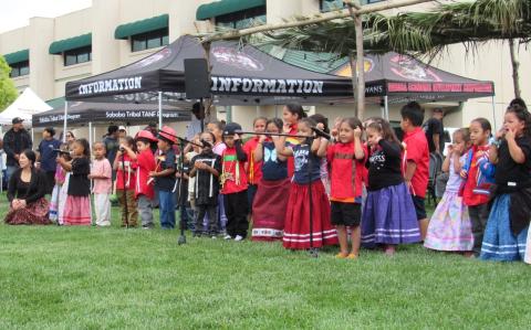 Soboba Tribal Preschool teacher Julissa Garcia, far left, helps students present three songs in the Luiseño language for all visitors at the Soboba Fiesta Soboba Tribal Preschool teacher Julissa Garcia, far left, helps students present three songs in the Luiseño language for all visitors at the Soboba Fiesta