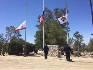 Frank Gallerito-Basquez (Navy), Primo Reynoso (Marines) and Fire Chief Randy Sandoval of the Soboba Fire Department raise the flags to full-staff while a bugler plays "Taps" Frank Gallerito-Basquez (Navy), Primo Reynoso (Marines) and Fire Chief Randy Sandoval of the Soboba Fire Department raise the flags to full-staff while a bugler plays "Taps"