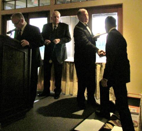 San Jacinto High School scholar-athlete Kevin Maria, right, is congratulated by NFF President Bill Powell as he takes the stage to receive his plaque and medallion at the scholar-athlete awards banquet on March 25 San Jacinto High School scholar-athlete Kevin Maria, right, is congratulated by NFF President Bill Powell as he takes the stage to receive his plaque and medallion at the scholar-athlete awards banquet on March 25