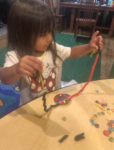 Clover Swan “beads” her necklace, one of many activities that Soboba Tribal Preschool students did at home during Native American Week studies Clover Swan “beads” her necklace, one of many activities that Soboba Tribal Preschool students did at home during Native American Week studies