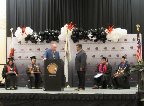 Principal Donovan Post, at the podium, asks Soboba Tribal Council Chairman Isaiah Vivanco to accept the nomination of Noli Indian School seniors for graduation Principal Donovan Post, at the podium, asks Soboba Tribal Council Chairman Isaiah Vivanco to accept the nomination of Noli Indian School seniors for graduation