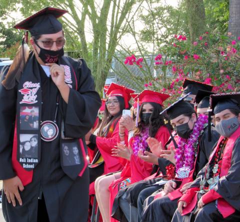 Raymond Masiel passes by fellow Noli Indian School graduates as he accepts his diploma on June 2 Raymond Masiel passes by fellow Noli Indian School graduates as he accepts his diploma on June 2