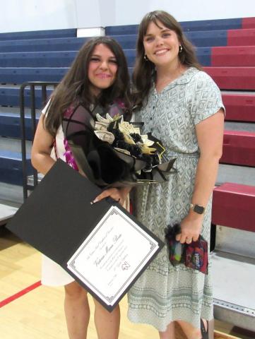 Victoria Boiso and teacher and AVID Coordinator Lorin Alvarez, share a moment after the Noli Indian School 8th Grade Promotion at the Soboba Sports Complex Victoria Boiso and teacher and AVID Coordinator Lorin Alvarez, share a moment after the Noli Indian School 8th Grade Promotion at the Soboba Sports Complex