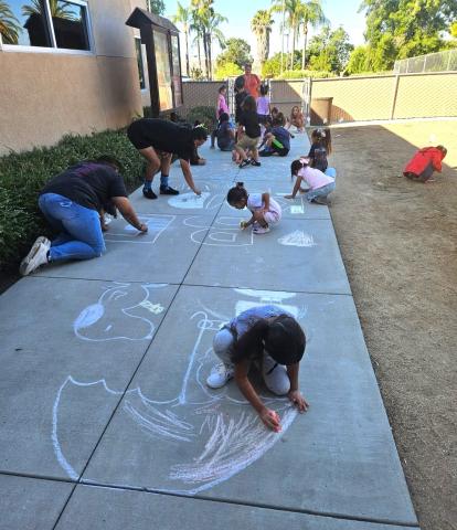 Kindergartners use chalk to create positive messages as part of a Kindness Week celebration facilitated by Rachelle Peterson Kindergartners use chalk to create positive messages as part of a Kindness Week celebration facilitated by Rachelle Peterson
