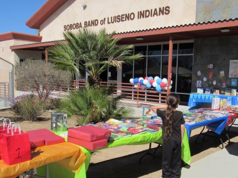 A young student looks over available books at the Soboba Tribal Preschool during Read Across America Day on March 2 A young student looks over available books at the Soboba Tribal Preschool during Read Across America Day on March 2