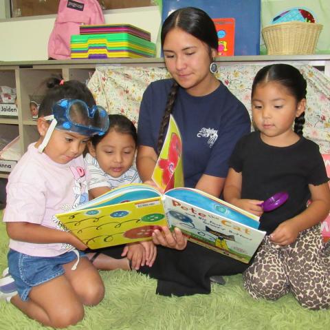 Preschool teacher’s aide Jess Thompson reads a favorite book to students. From left, Asoovi Maxcy, Tomahawk Calderon, Ms. Jess, and Neexish Alvarez Preschool teacher’s aide Jess Thompson reads a favorite book to students. From left, Asoovi Maxcy, Tomahawk Calderon, Ms. Jess, and Neexish Alvarez