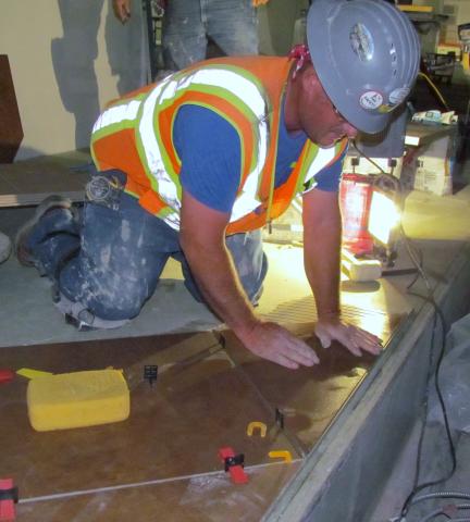 Steve Minichiello lays tile in the main area of the replacement casino Steve Minichiello lays tile in the main area of the replacement casino