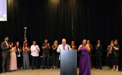 Incoming HSJVC Chair Patricia Scott accepts the gavel from outgoing Chair Frank Barrickman while members of the Board of Directors applaud her Incoming HSJVC Chair Patricia Scott accepts the gavel from outgoing Chair Frank Barrickman while members of the Board of Directors applaud her