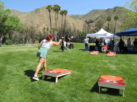 A player tries her hand at Cornhole Craze on the golf course’s sixth hole. She is assisted by Hemet Youth Wrestling Club volunteers Vanessa Higuera and Matthew Brant. Soboba Band of Luiseño Indians photo A player tries her hand at Cornhole Craze on the golf course’s sixth hole. She is assisted by Hemet Youth Wrestling Club volunteers Vanessa Higuera and Matthew Brant. Soboba Band of Luiseño Indians photo
