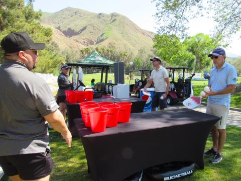 Oak Grove Institute Foundation volunteers Erick Montejo and Romy Fazeli, at left, help players with the Pickleball Pong game on Hole 8. Soboba Band of Luiseño Indians photo Oak Grove Institute Foundation volunteers Erick Montejo and Romy Fazeli, at left, help players with the Pickleball Pong game on Hole 8. Soboba Band of Luiseño Indians photo