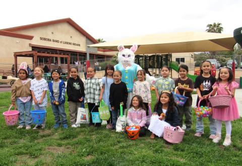 Kindergarten students with the Easter bunny after completing a hunt for hundreds of Easter eggs hidden on their playground Kindergarten students with the Easter bunny after completing a hunt for hundreds of Easter eggs hidden on their playground