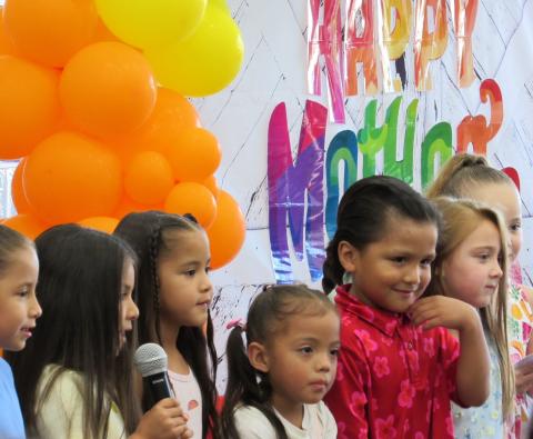 Pre-kindergarten students get into their performance for their moms at a special Mother’s Day event Pre-kindergarten students get into their performance for their moms at a special Mother’s Day event