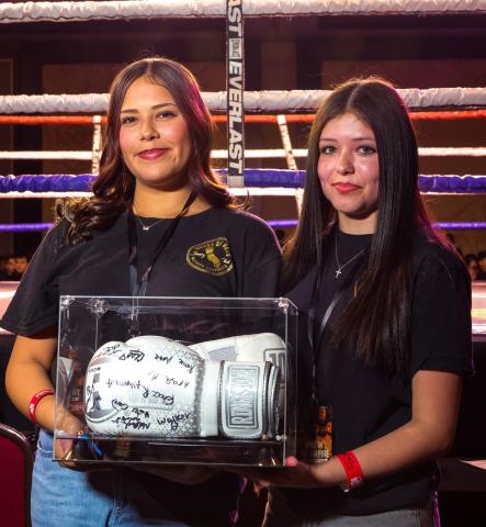 House of Pain So Cal Youth Mentorship Program members Lillian Deisher, left, and Amaya Abbas with a pair of boxing gloves signed by other youth participants and presented to Soboba Tribal Council during the War in the Empire event House of Pain So Cal Youth Mentorship Program members Lillian Deisher, left, and Amaya Abbas with a pair of boxing gloves signed by other youth participants and presented to Soboba Tribal Council during the War in the Empire event