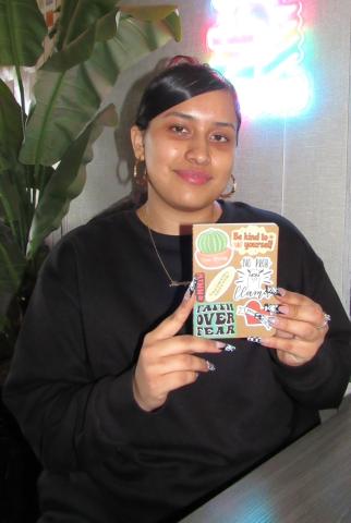 Monique Russell shows the cover of the pocket journal she decorated to celebrate kindness Monique Russell shows the cover of the pocket journal she decorated to celebrate kindness