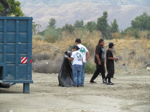 Environmental Specialist Jennifer Salazar and Environmental Manager Steven Estrada, center, pick up loose trash as Soboba TANF youth make their way to help with other disposal during the Soboba Environmental Department’s annual Community Cleanup Event last month Environmental Specialist Jennifer Salazar and Environmental Manager Steven Estrada, center, pick up loose trash as Soboba TANF youth make their way to help with other disposal during the Soboba Environmental Department’s annual Community Cleanup Event last month