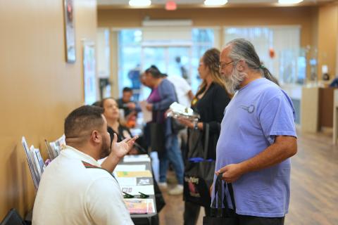 Patient Advocate Hunter Fields, left, talks about programs with visitors to his table during a Patient Appreciation Day event Patient Advocate Hunter Fields, left, talks about programs with visitors to his table during a Patient Appreciation Day event