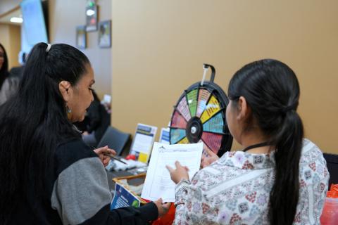 Visitors receive information from a representative for Native Challenge Visitors receive information from a representative for Native Challenge