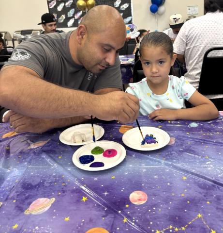Lewis Cervantes helps his pre-K daughter Delilah with a painting project they did together at the Soboba Tribal Preschool, May 23 Lewis Cervantes helps his pre-K daughter Delilah with a painting project they did together at the Soboba Tribal Preschool, May 23