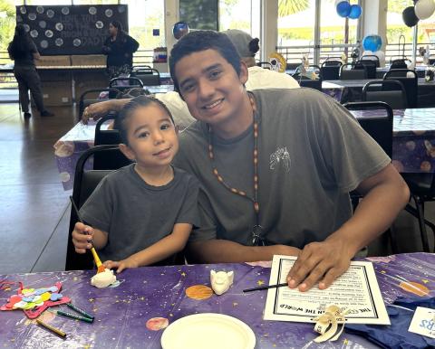 Damian Mariscal with preschooler Paa’at get ready to paint their astronaut and rocket ship activity offered at the early Father’s Day celebration Damian Mariscal with preschooler Paa’at get ready to paint their astronaut and rocket ship activity offered at the early Father’s Day celebration