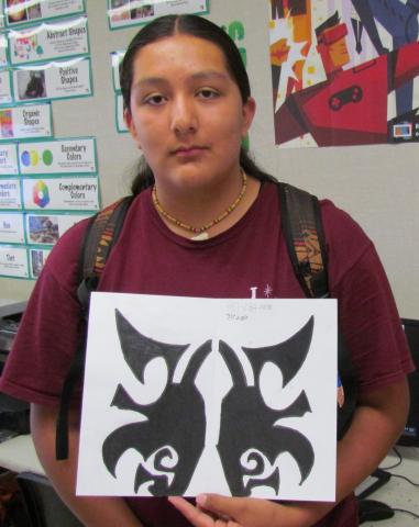Matthew Tewawina shows the logo design he will incorporate for his hypothetical business, Tribal Tattoos, as part of a graphic arts project Matthew Tewawina shows the logo design he will incorporate for his hypothetical business, Tribal Tattoos, as part of a graphic arts project