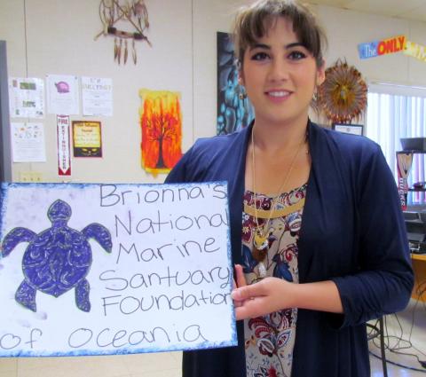 Noli Indian School art teacher, Danielle Grass, shows a student’s idea for a hypothetical business. Brionna Hernandez wants to be a marine biologist so that theme was incorporated into her graphic arts project design Noli Indian School art teacher, Danielle Grass, shows a student’s idea for a hypothetical business. Brionna Hernandez wants to be a marine biologist so that theme was incorporated into her graphic arts project design