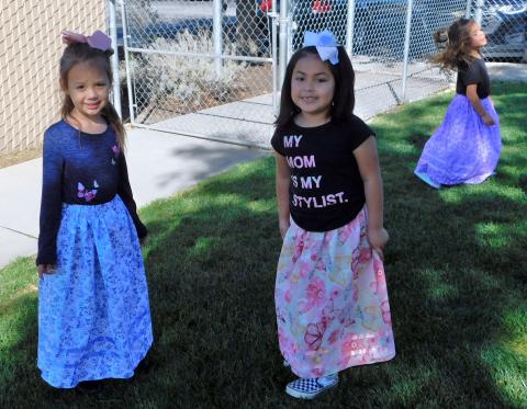 Rihanna Kashersky, left, and Marilyn Mendoza show off their new camp dresses while Tulóvat Témanxwanvish, in background, plays in hers Rihanna Kashersky, left, and Marilyn Mendoza show off their new camp dresses while Tulóvat Témanxwanvish, in background, plays in hers
