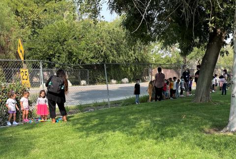 Preschoolers wait in a safe location after being led away from the school during a recent practice fire drill Preschoolers wait in a safe location after being led away from the school during a recent practice fire drill