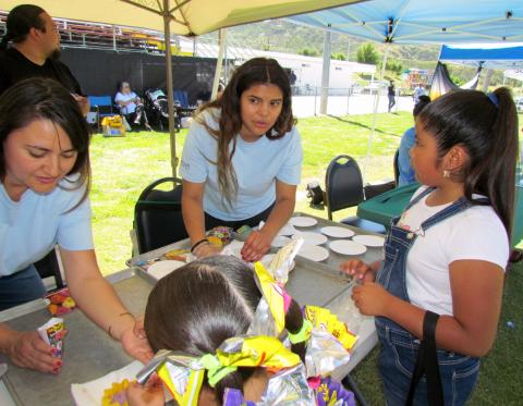 Soboba Tribal TANF Program Specialist Olga Gomez, center, helps visitors make take home flower starters at the 13th annual Soboba Tribal Earth Day celebration on April 18 Soboba Tribal TANF Program Specialist Olga Gomez, center, helps visitors make take home flower starters at the 13th annual Soboba Tribal Earth Day celebration on April 18