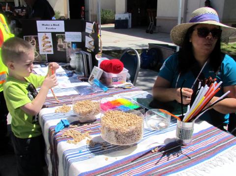 Logan Tolson, 4, makes a bird feeder as Riverside-San Bernardino County Indian Health Native Challenge program parent partner Ingrid Bradley talks to visitors about the importance of parent/child interaction Logan Tolson, 4, makes a bird feeder as Riverside-San Bernardino County Indian Health Native Challenge program parent partner Ingrid Bradley talks to visitors about the importance of parent/child interaction