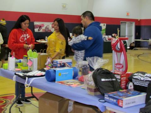 Ricardo Macias, right, and other health fair organizers call out winners during one of the opportunity drawings Ricardo Macias, right, and other health fair organizers call out winners during one of the opportunity drawings