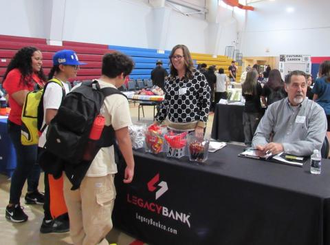 Legacy Bank’s Cyndi Lemke, left, shares financial information with students and Noli math teacher Kekai Bryant while CEO Bill Nethercott engages with others at the Noli Career and College Fair Legacy Bank’s Cyndi Lemke, left, shares financial information with students and Noli math teacher Kekai Bryant while CEO Bill Nethercott engages with others at the Noli Career and College Fair