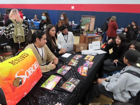 Soboba Casino Resort marketing team members, from left, Nathan Miranda, Corryn Salgado-Flores and Wade Abbas discuss their jobs with students at the Noli Indian School Career and College Fair, Nov. 28