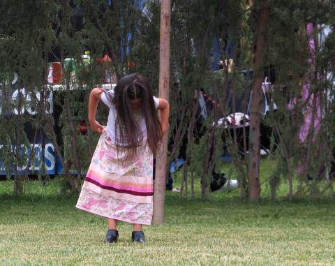 A young participant in the Cake Walk lifts her bird skirt to see what number she is standing on when the music stops, hoping she’s a winner A young participant in the Cake Walk lifts her bird skirt to see what number she is standing on when the music stops, hoping she’s a winner