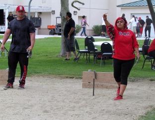 Noli Indian School senior Alyssa Soza pitches a horseshoe as counselor Clyde Miller looks on during the school’s Annual Fiesta Noli Indian School senior Alyssa Soza pitches a horseshoe as counselor Clyde Miller looks on during the school’s Annual Fiesta