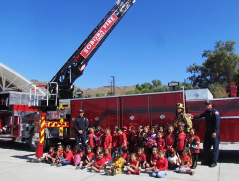 Students from the Soboba Tribal Preschool gather in front of the department’s 107-foot Tiller Ladder Truck during a field trip to Soboba Fire Station No. 1 on Oct. 11.