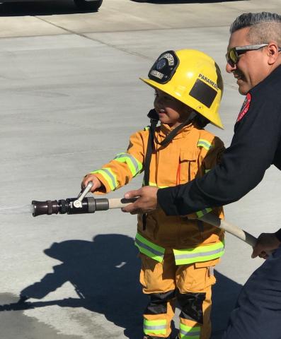 Mini-firefighter Clementine Swan, 4, gets a lesson in using a fire hose from Soboba Fire Department’s Richard Gilmartin during a field trip by Soboba Tribal Preschool students to the firehouse on Oct. 11. Mini-firefighter Clementine Swan, 4, gets a lesson in using a fire hose from Soboba Fire Department’s Richard Gilmartin during a field trip by Soboba Tribal Preschool students to the firehouse on Oct. 11.