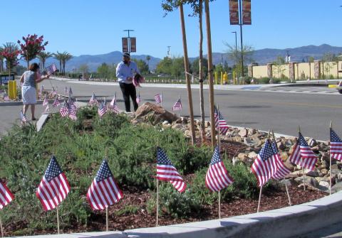 Soboba Casino Resort employee Angel Salazar, center, helps a guest place flags at the site on the morning of July 4 Soboba Casino Resort employee Angel Salazar, center, helps a guest place flags at the site on the morning of July 4