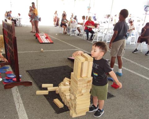 Oliver Orich, 3, builds a wooden tower while other children play games during the family-friendly Food Truck Fiesta at Soboba Casino Resort Oliver Orich, 3, builds a wooden tower while other children play games during the family-friendly Food Truck Fiesta at Soboba Casino Resort
