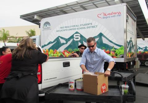 Soboba Tribal members Dondi Silvas and Wade Abbas assist SJUSD Superintendent Dave Pyle, at right and a SJUSD Nutrition Services worker, far left, in loading up a vehicle with turkey dinner and all the fixings during the Soboba turkey giveaway event at San Jacinto High School on Nov. 19 Soboba Tribal members Dondi Silvas and Wade Abbas assist SJUSD Superintendent Dave Pyle, at right and a SJUSD Nutrition Services worker, far left, in loading up a vehicle with turkey dinner and all the fixings during the Soboba turkey giveaway event at San Jacinto High School on Nov. 19