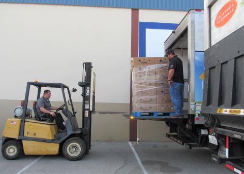 HUSD’s Nutrition Services warehouse manager, Sonny Rachunok, drives a forklift to the back of a refrigerated truck where head delivery driver Matt Perez has positioned more 22-pound turkeys for distribution on Nov. 20 HUSD’s Nutrition Services warehouse manager, Sonny Rachunok, drives a forklift to the back of a refrigerated truck where head delivery driver Matt Perez has positioned more 22-pound turkeys for distribution on Nov. 20