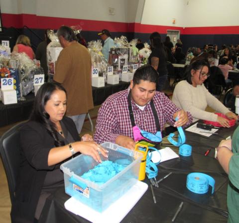 Among the many volunteers helping to make the night successful are, from left, Geneva Mojado, Christian Aceves and Karla Valdez, who stayed busy selling tickets for raffle prizes and a 50/50 drawing Among the many volunteers helping to make the night successful are, from left, Geneva Mojado, Christian Aceves and Karla Valdez, who stayed busy selling tickets for raffle prizes and a 50/50 drawing