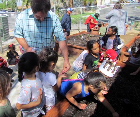Noli Indian School science and agriculture teacher Jay Dagostino gives students seeds to plant in the new raised bed garden at the Soboba Tribal Preschool on April 17 Noli Indian School science and agriculture teacher Jay Dagostino gives students seeds to plant in the new raised bed garden at the Soboba Tribal Preschool on April 17