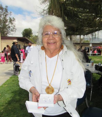 One of the guests at the gathering, Mary Masiel, shows the handmade earrings she chose as a raffle prize after having one of the winning tickets One of the guests at the gathering, Mary Masiel, shows the handmade earrings she chose as a raffle prize after having one of the winning tickets