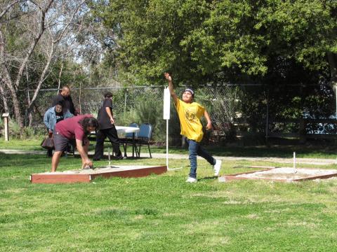 Players practice after signing up to compete in games of horseshoes at Noli Indian School Players practice after signing up to compete in games of horseshoes at Noli Indian School